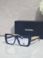 Chanel glasses with dark blue frames, clear lenses, gold-tone temples and logo