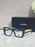 Chanel glasses with dark blue frames and clear lenses, gold-tone temple arms