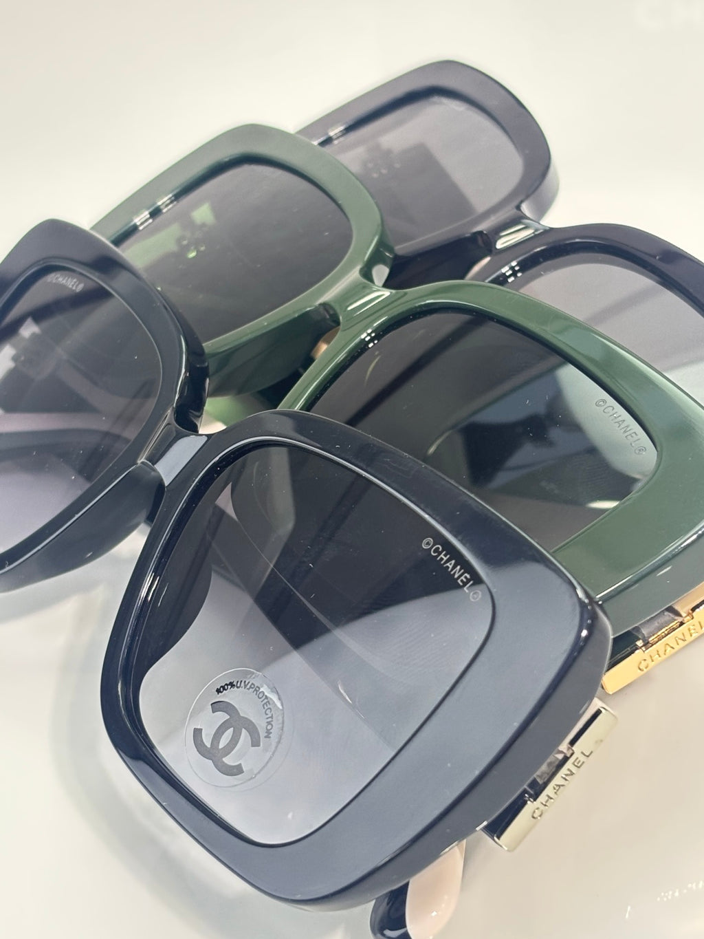 Chanel glasses multiple angles showing dark blue frame with green-tinted lens and gold hinge