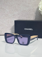 Chanel glasses with dark blue frames, square lenses, and gold-tone side logo details