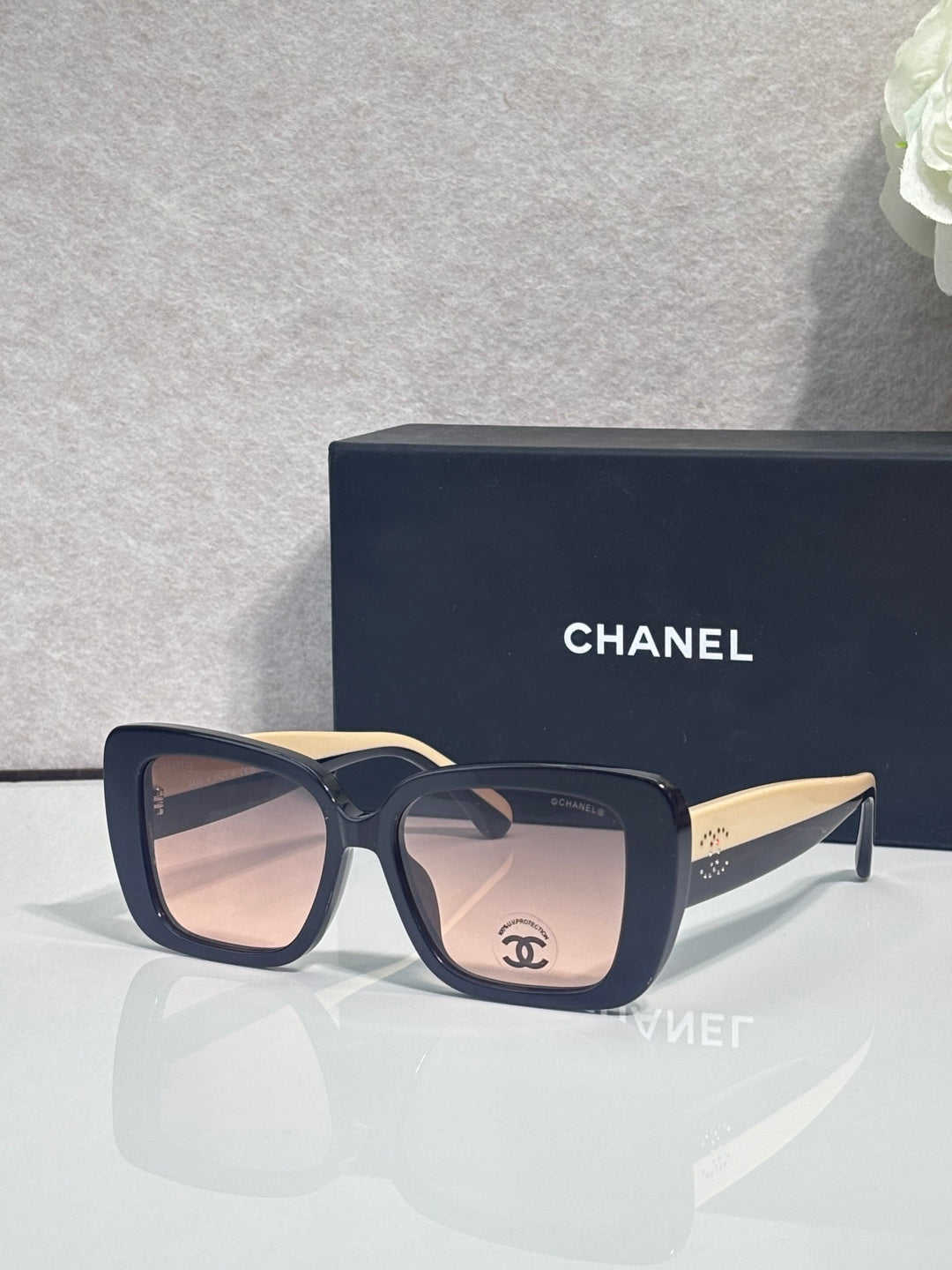 Chanel glasses with dark blue acetate frames and gold-tone temple tips, square lenses