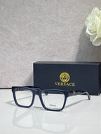 Versace eyeglasses, dark acetate frame with clear lenses and gold-tone temple details
