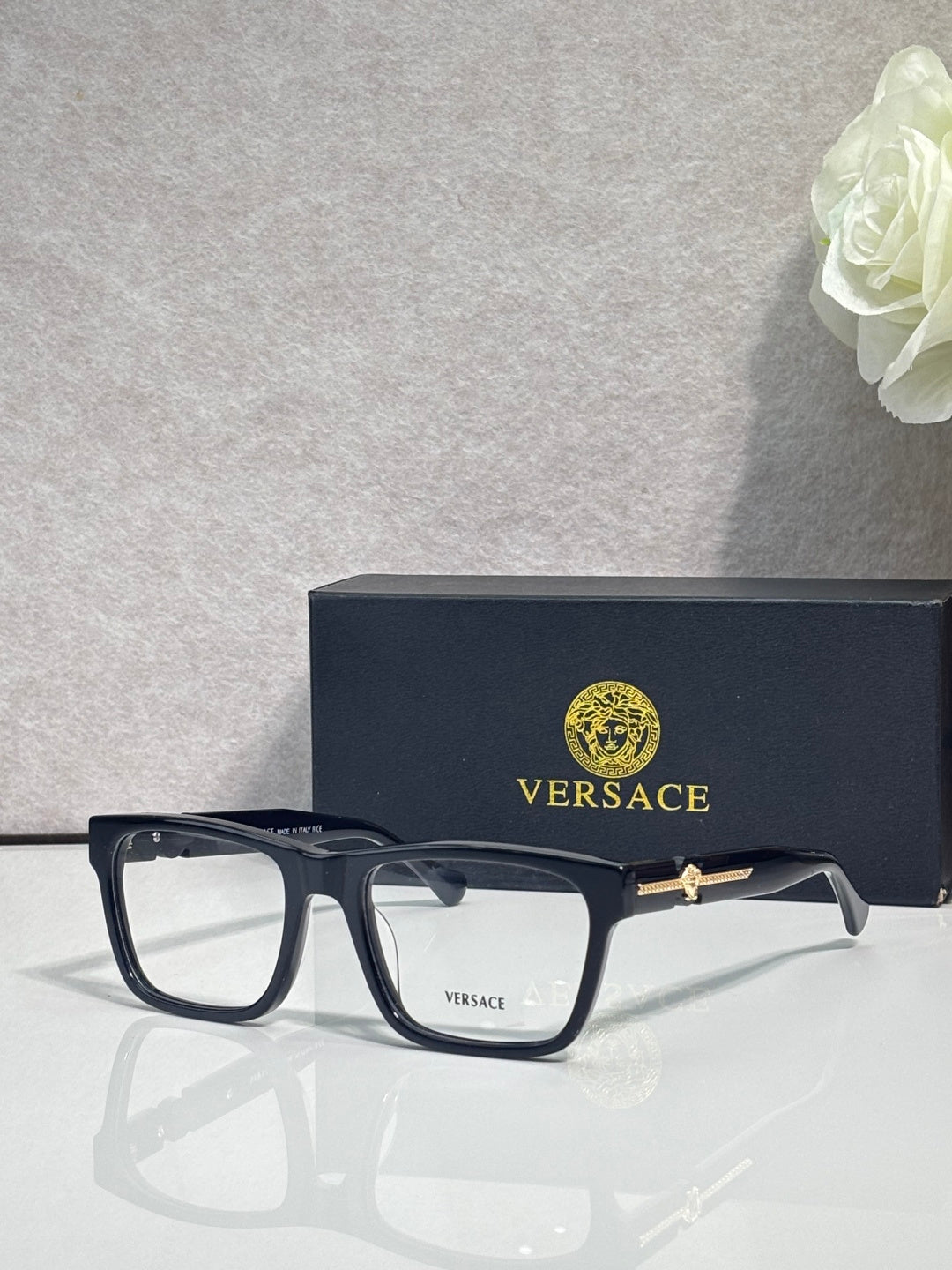 Versace eyeglasses, dark tortoiseshell acetate frame with clear lenses and gold accents