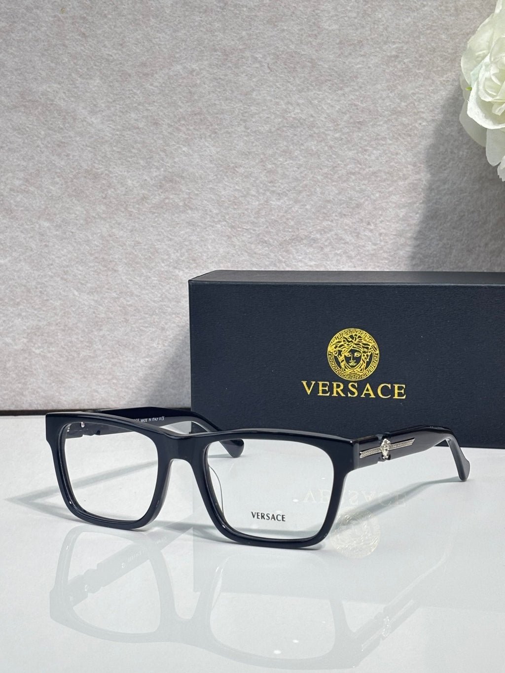 Versace eyeglasses, dark acetate frame with clear lenses and gold temple hinge detail