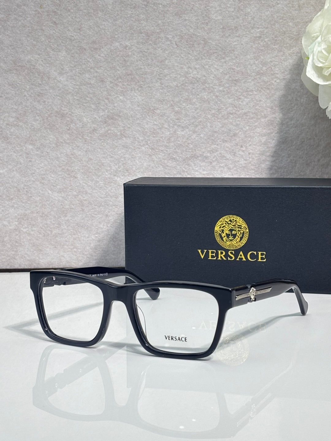 Versace eyeglasses, dark acetate frame with clear lenses and gold temple hinge detail