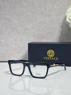 Versace eyeglasses with dark acetate frame, clear lenses, and gold bridge logo