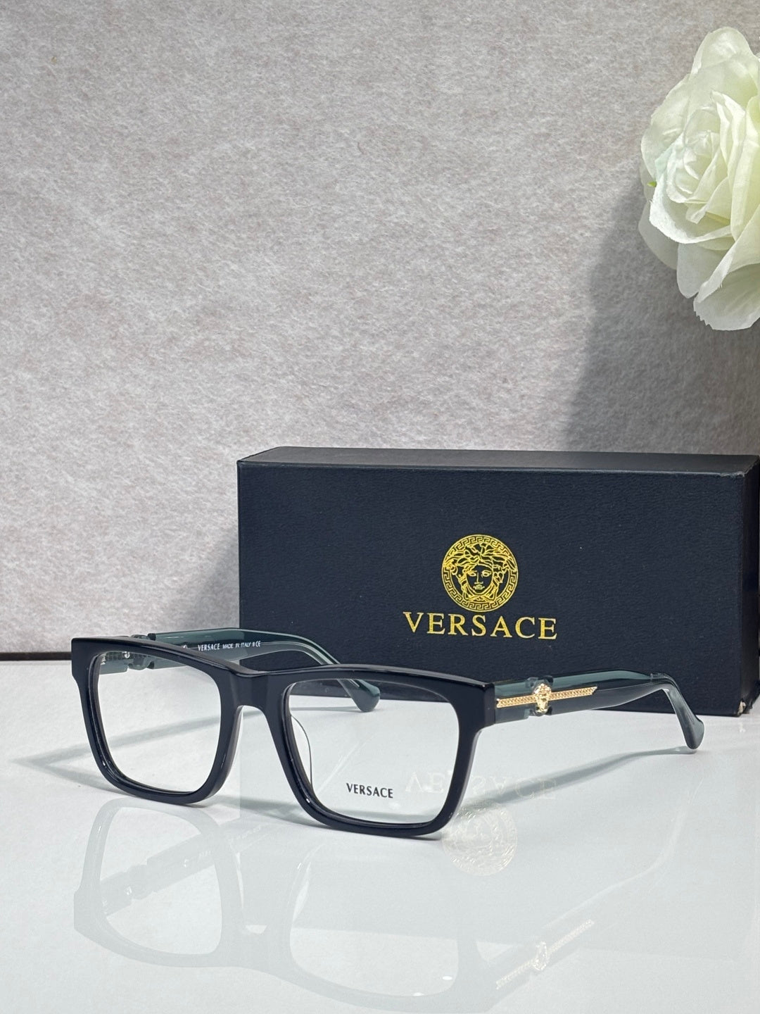 Versace eyeglasses, dark acetate frame with clear lenses and small gold emblem on temple