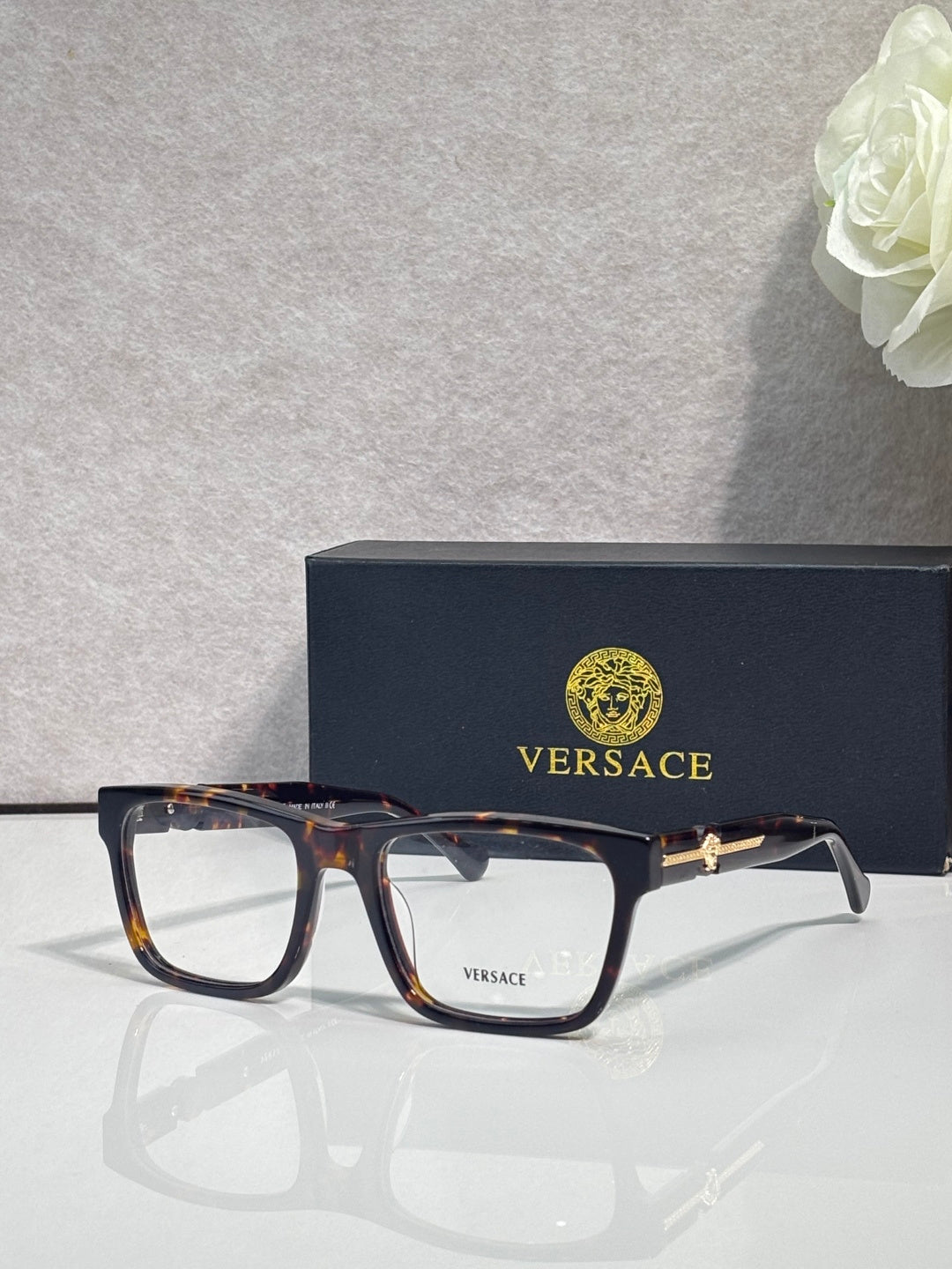 Versace eyeglasses, amber tortoiseshell acetate frame with clear lenses and gold logo