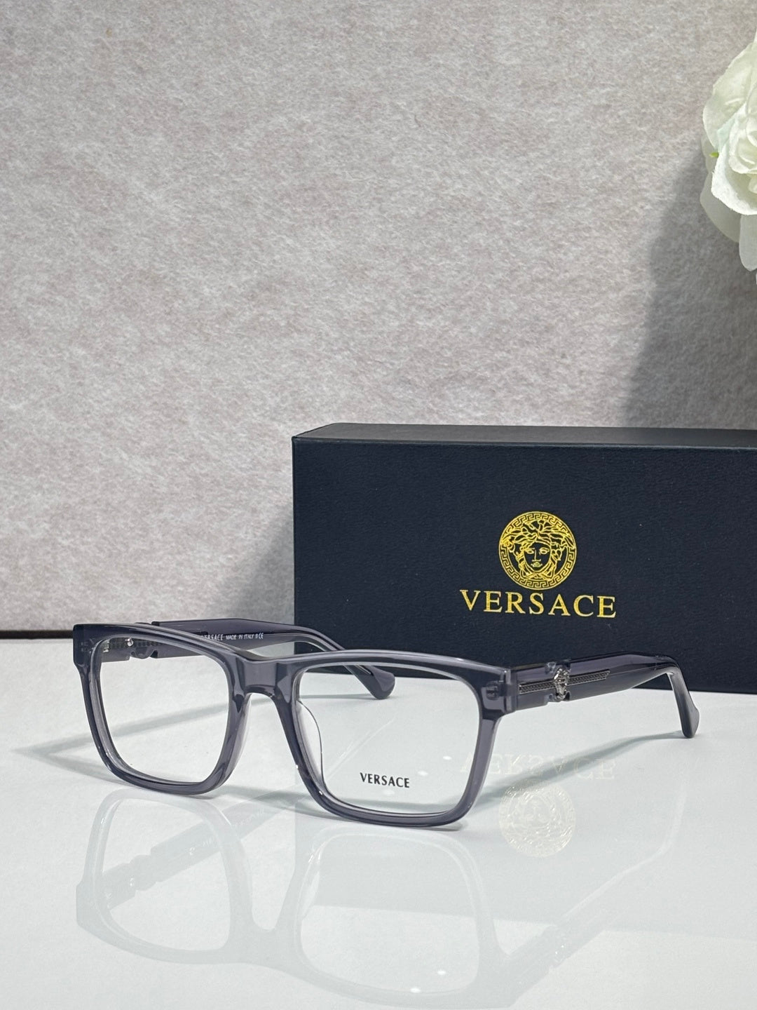 Versace eyeglasses, dark rectangular acetate frame with clear lenses and gold logo detail