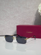 Rectangular eyeglasses with gold frame, dark blue lenses, and black temple arms