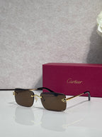 Rectangular eyeglasses with gold frame, dark brown lenses, and black temple arms