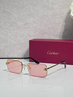 Rectangular eyeglasses with gold frame, light pink lenses, and black temple arms