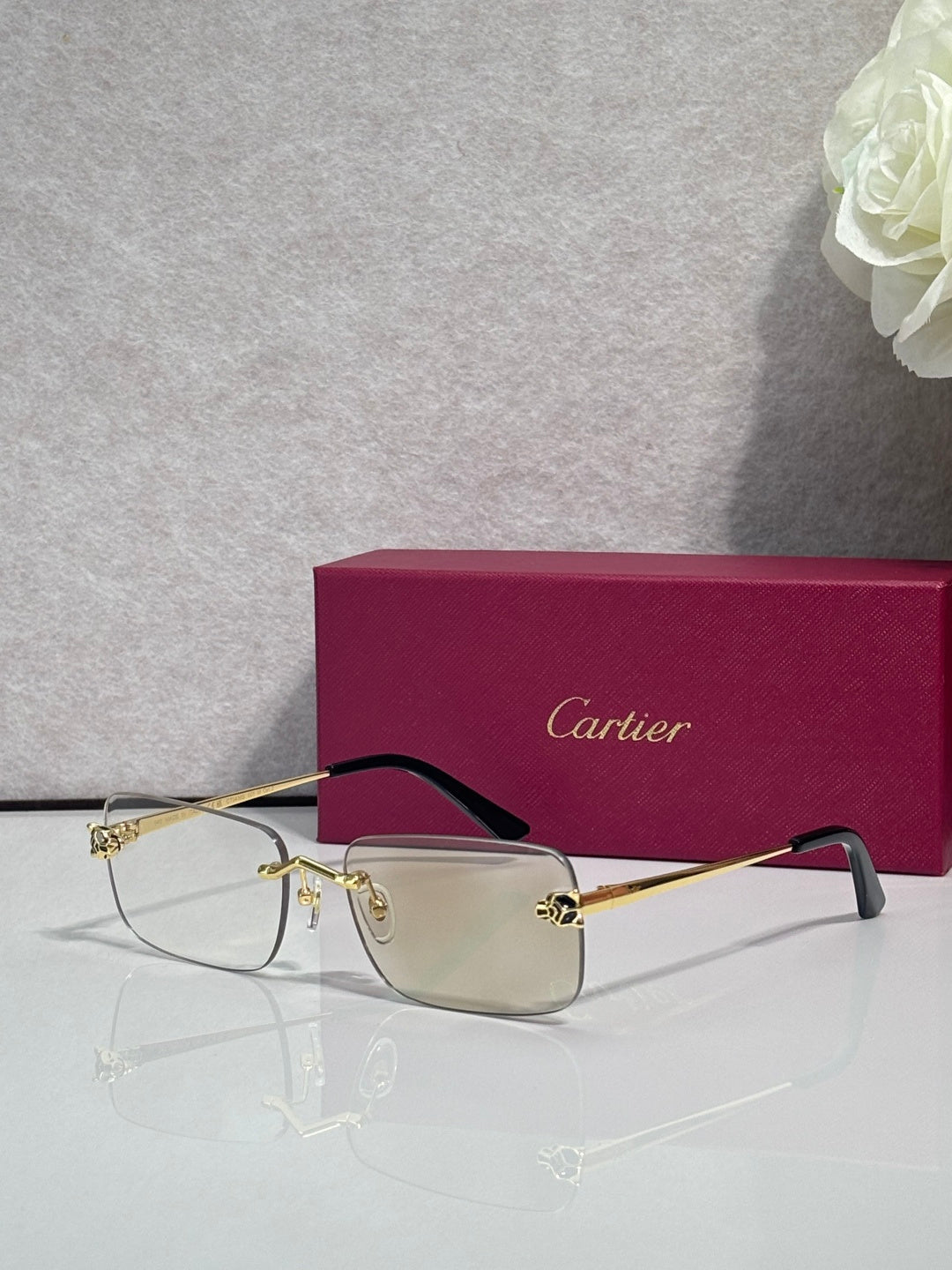 Rectangular eyeglasses with gold metal frame and clear lenses, dark bridge accents