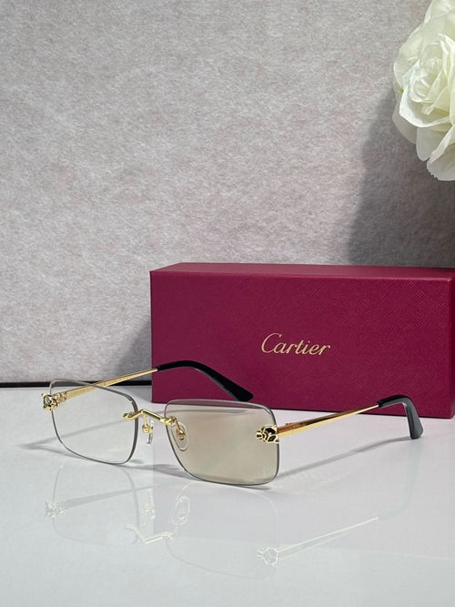 Rectangular eyeglasses with gold metal frame and clear lenses, dark bridge accents