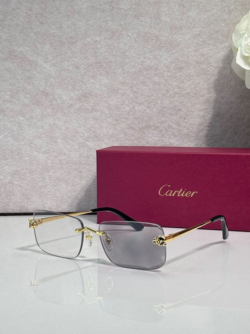 Rectangular eyeglasses with gold metal frame, clear lenses, and dark temple arms