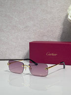 Rectangular eyeglasses with gold frame and light pink tinted lenses, black temple arms