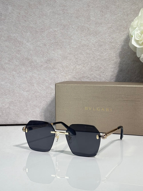 Square dark blue-gray sunglasses with black frame and gold hinge accents