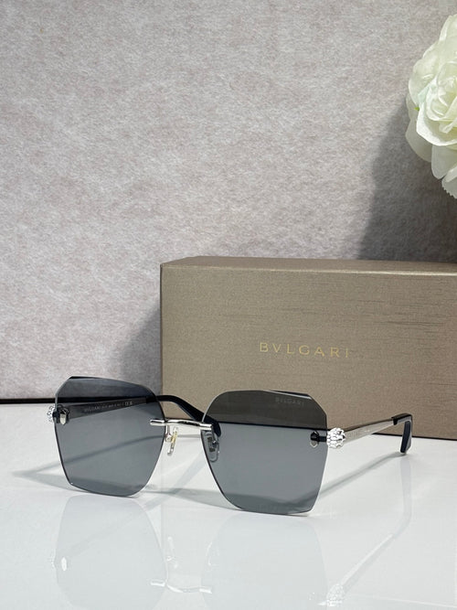 Square dark sunglasses with black frame and gold logo detail across bridge