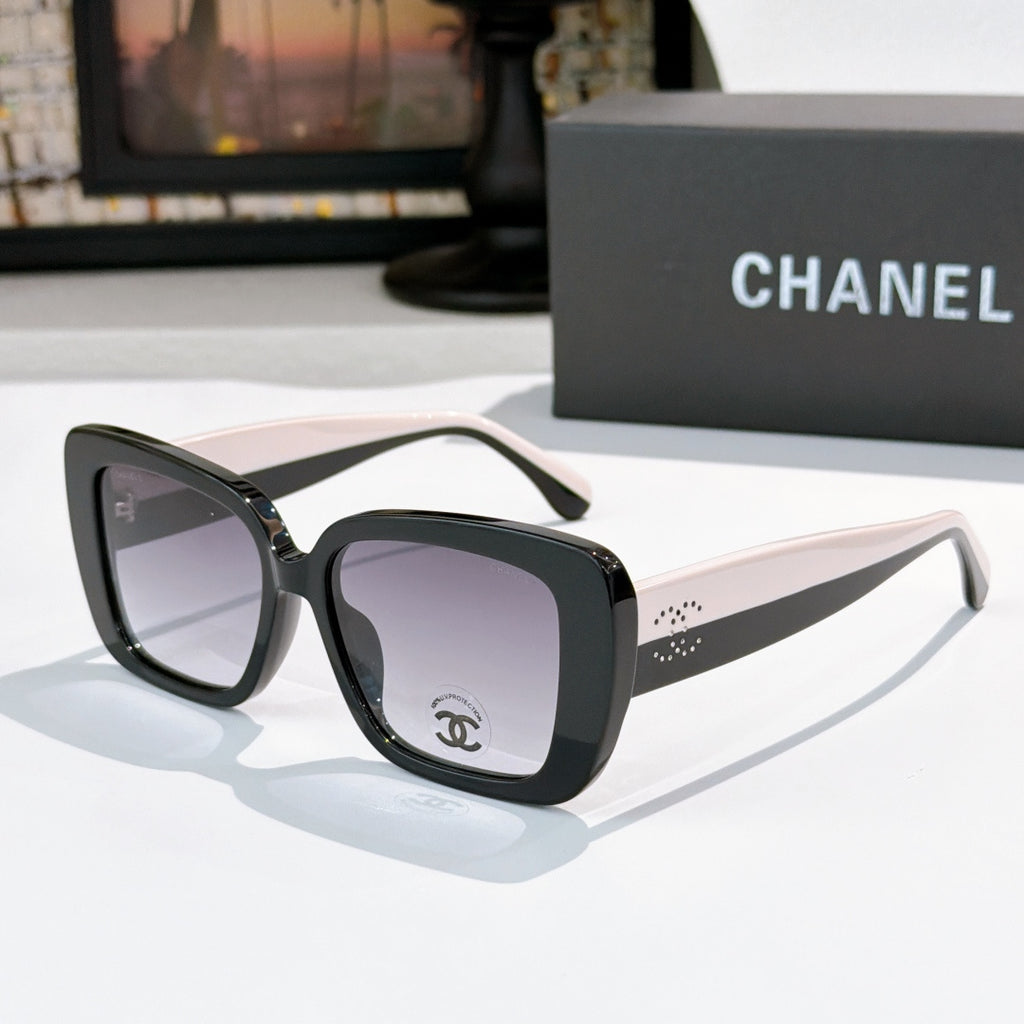 Chanel sunglasses with dark frame, light beige arms, gray tinted lenses