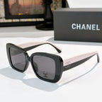 Chanel sunglasses with dark frame, white-beige arms, gray tinted lenses