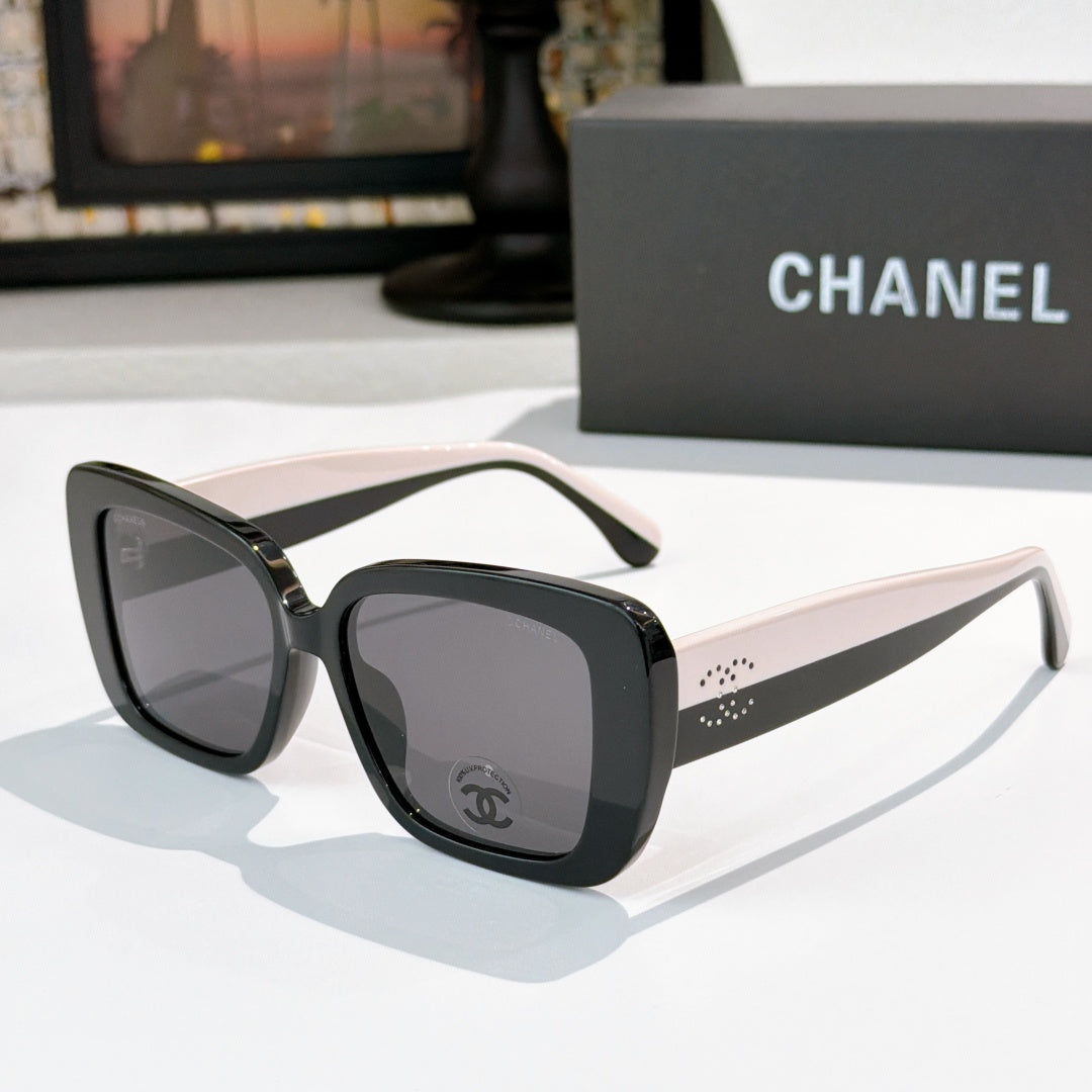 Chanel sunglasses with dark frame, white-beige arms, gray tinted lenses