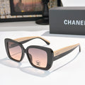 Chanel sunglasses with dark frame, light beige arms, pink tinted lenses