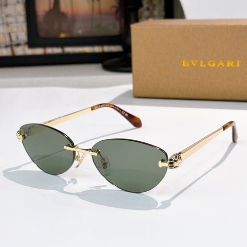 Gold oval sunglasses with green lenses, tortoise temple tips, jeweled bridge