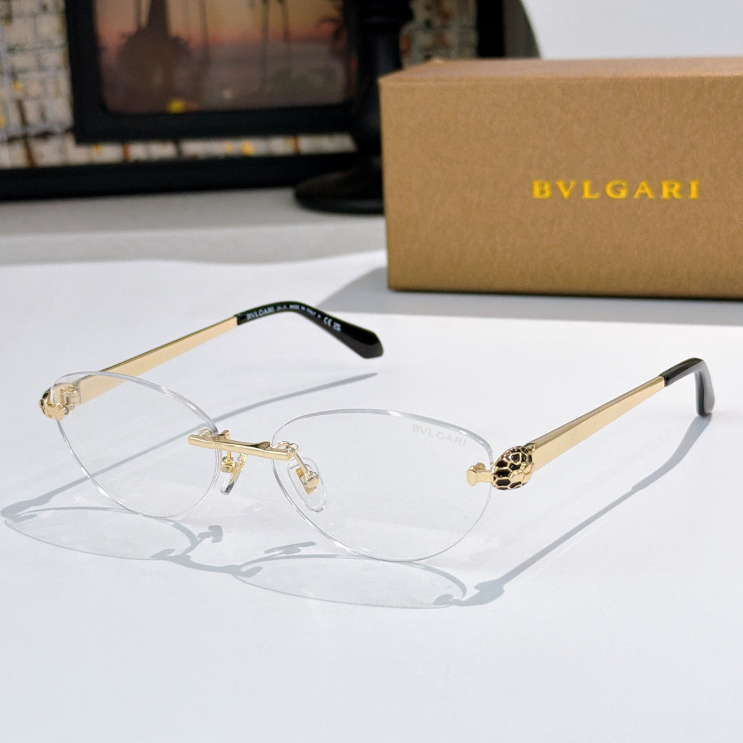 Gold oval eyeglasses with clear lenses and jeweled bridge