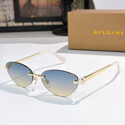Gold oval sunglasses with blue gradient lenses and jeweled double-bridge detail