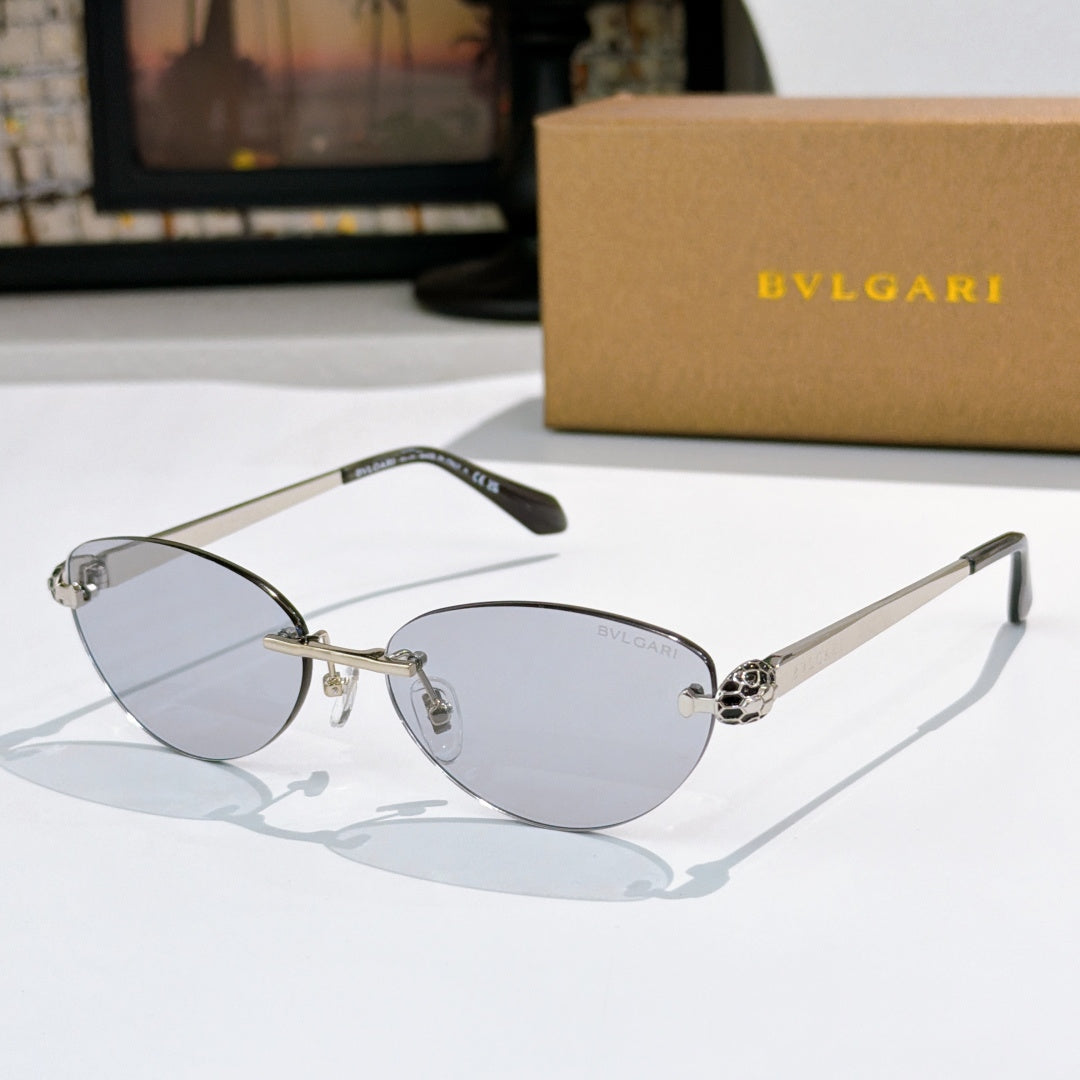 Gold oval sunglasses with light-blue lenses and jeweled bridge