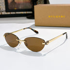 Gold oval sunglasses with brown lenses and jeweled bridge