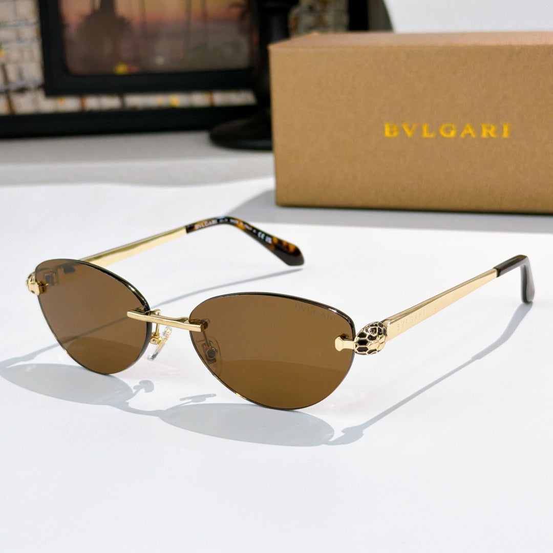 Gold oval sunglasses with brown lenses and jeweled bridge