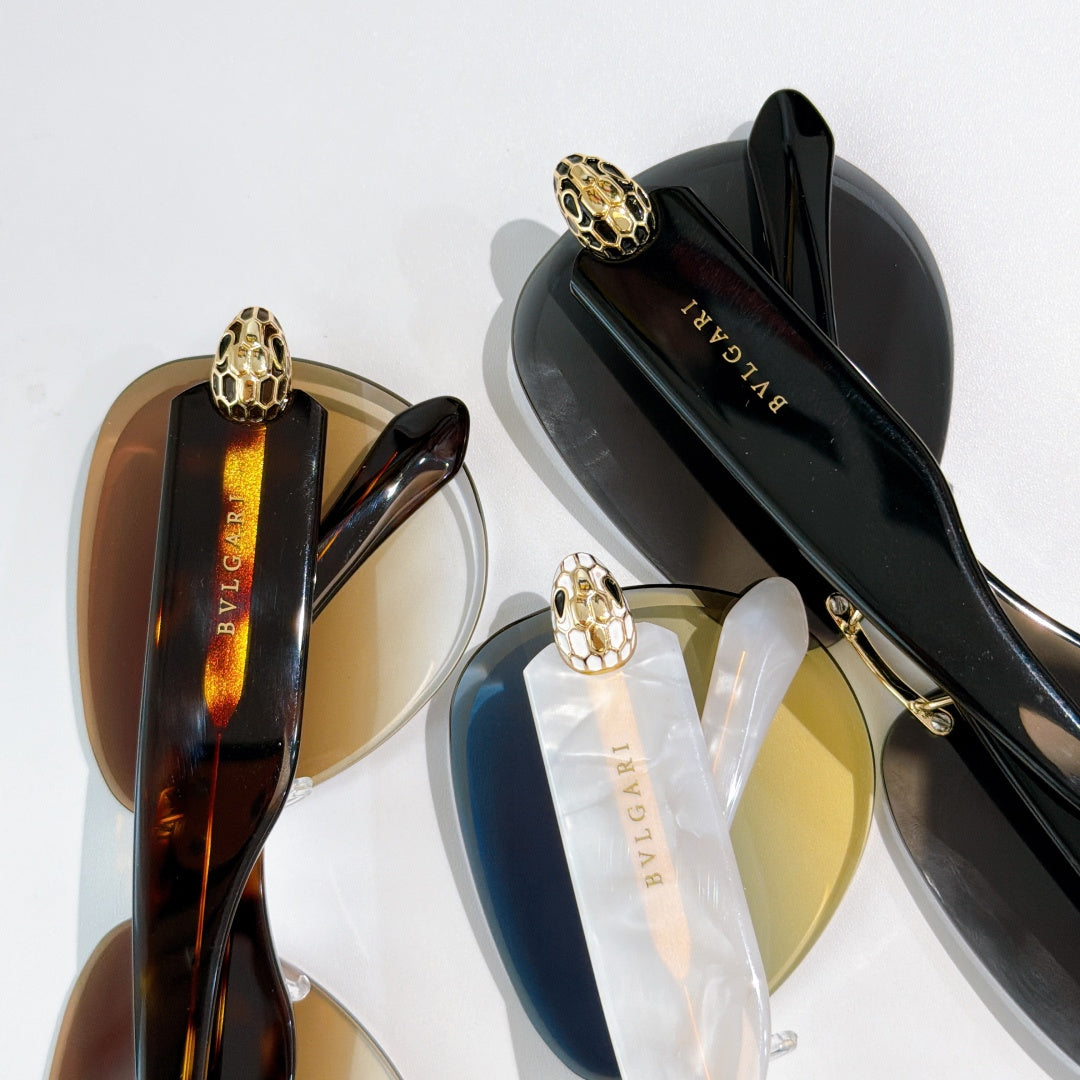 Bvlgari sunglasses close-up: black lenses, gold-toned frame, and gold emblem detail.