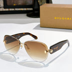 Bvlgari sunglasses with brown gradient lenses, tortoiseshell frame, and gold accents.