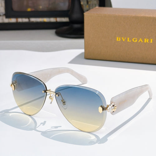 Bvlgari sunglasses with gradient blue lenses, transparent light frame, and gold detailing.