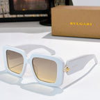 Square sunglasses, light blue frames with beige gradient lenses, gold logo on temples