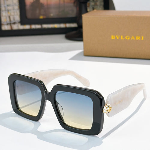 Square sunglasses, dark frames with blue gradient lenses, gold logo on temples