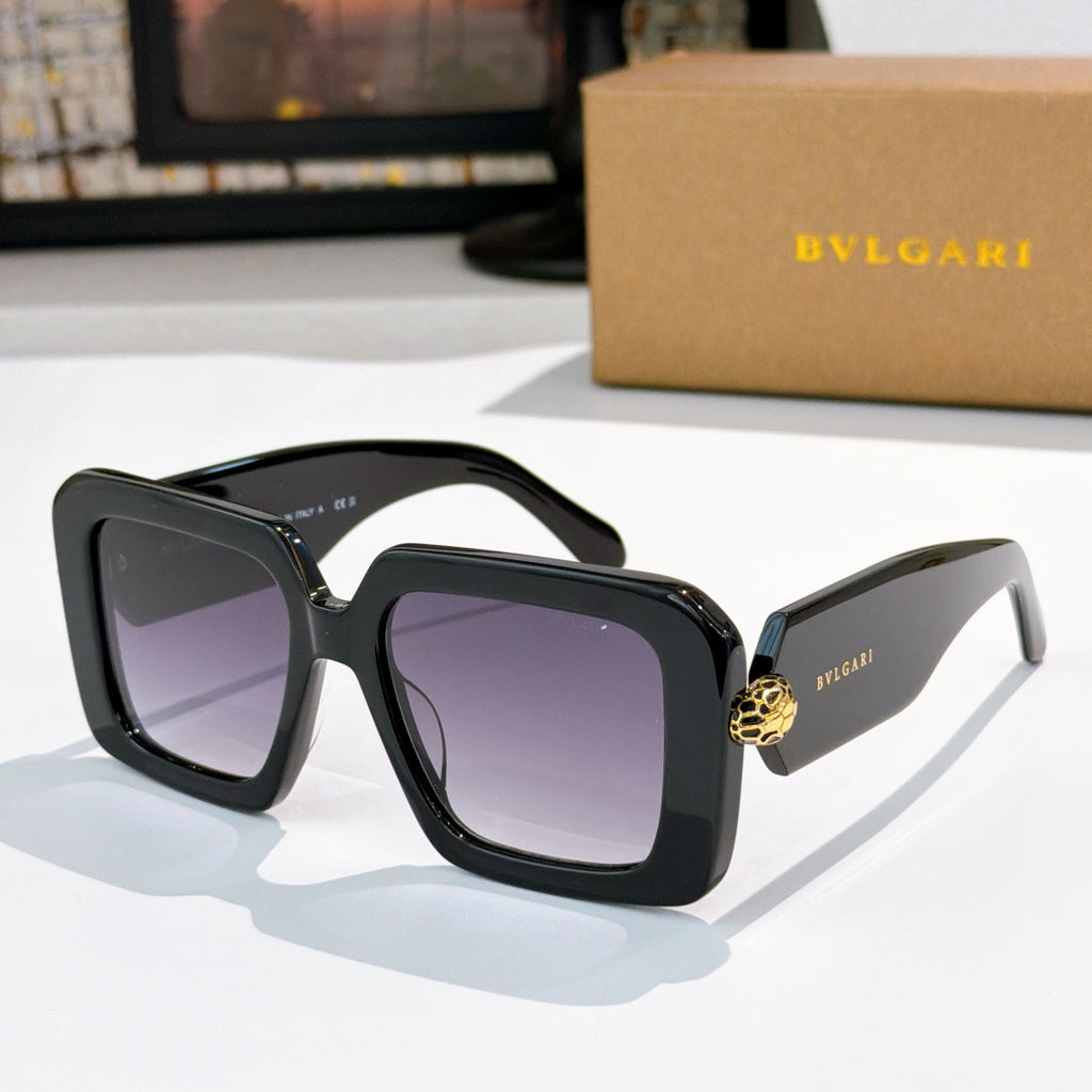 Square sunglasses, black frames with purple gradient lenses, gold logo on temples