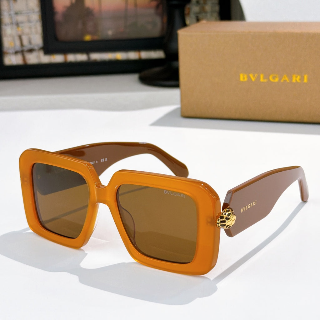 Square sunglasses, orange frames with brown gradient lenses, gold logo on temples