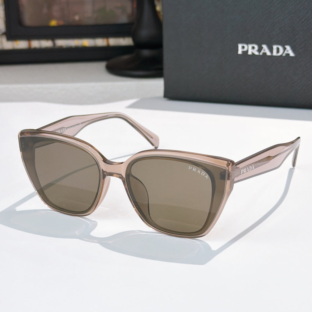 Sunglasses by Prada, light pink frame with brown-tinted lenses