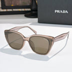 Sunglasses by Prada, light pink frame with brown-tinted lenses