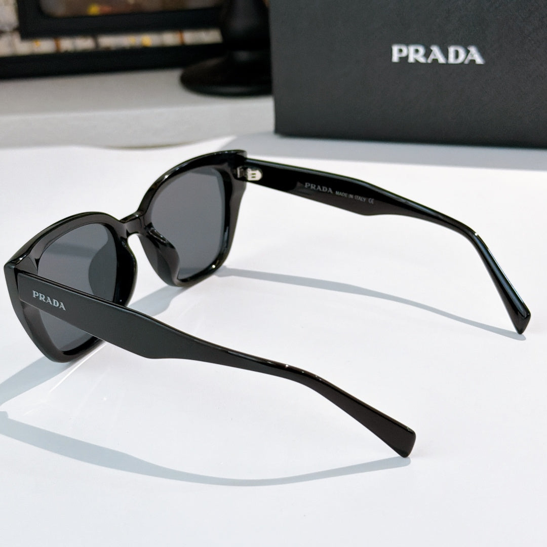Prada sunglasses, black frame with dark tinted lenses, side view