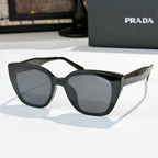 Sunglasses by Prada, black frame with dark tinted lenses