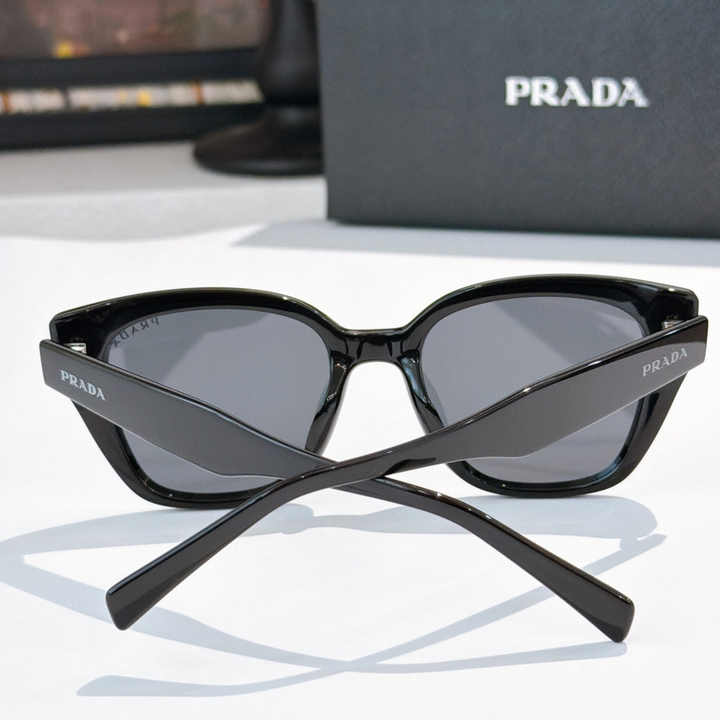 Prada sunglasses, black frame with dark tinted lenses, front view