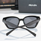 Prada sunglasses, black frame with dark tinted lenses, front view