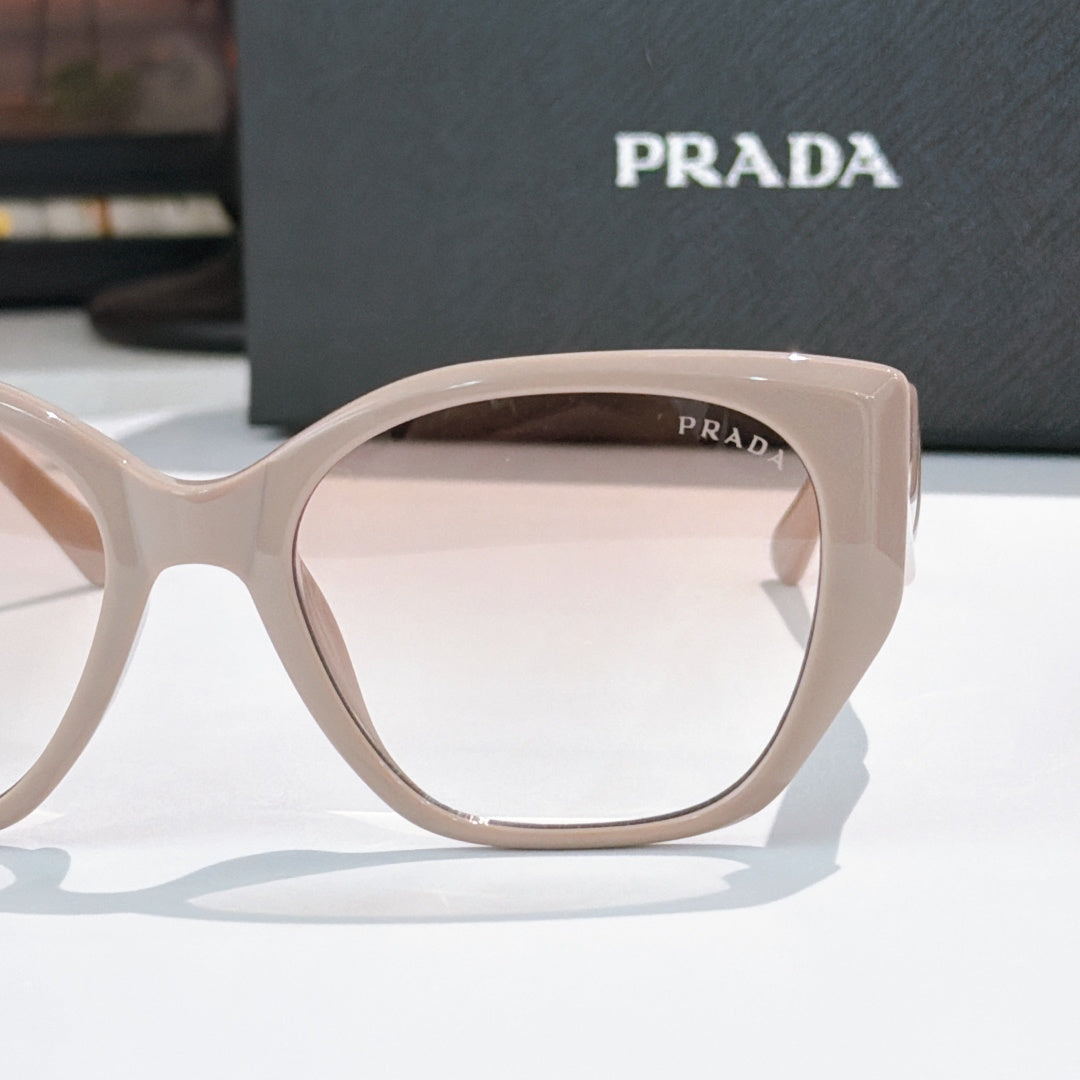 Prada light pink cat-eye sunglasses frame front with arched shape