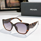 Prada cat-eye sunglasses with light lenses and tortoise translucent frames