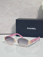 CHANEL sunglasses with gold frame, pink temples, tinted rose lenses.