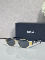 CHANEL sunglasses with gold frame, dark lenses, black temple tips.