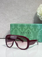 Gucci oversized sunglasses with burgundy frame and tinted lenses, with green logo case